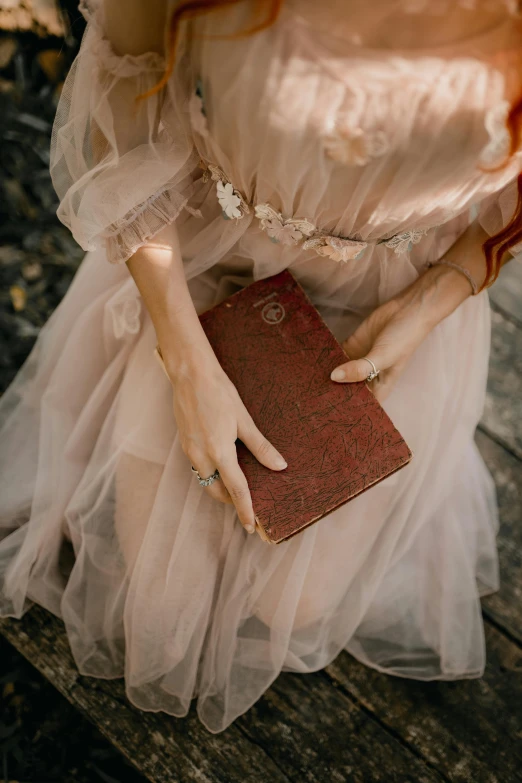 an image of a woman holding a book