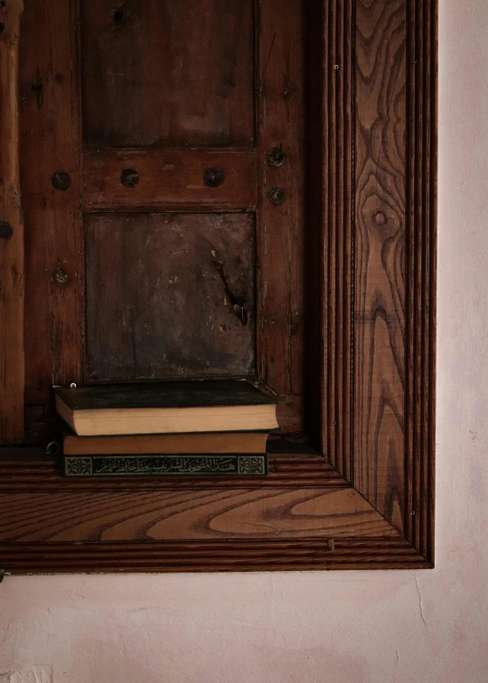 a wood frame with books sitting on top