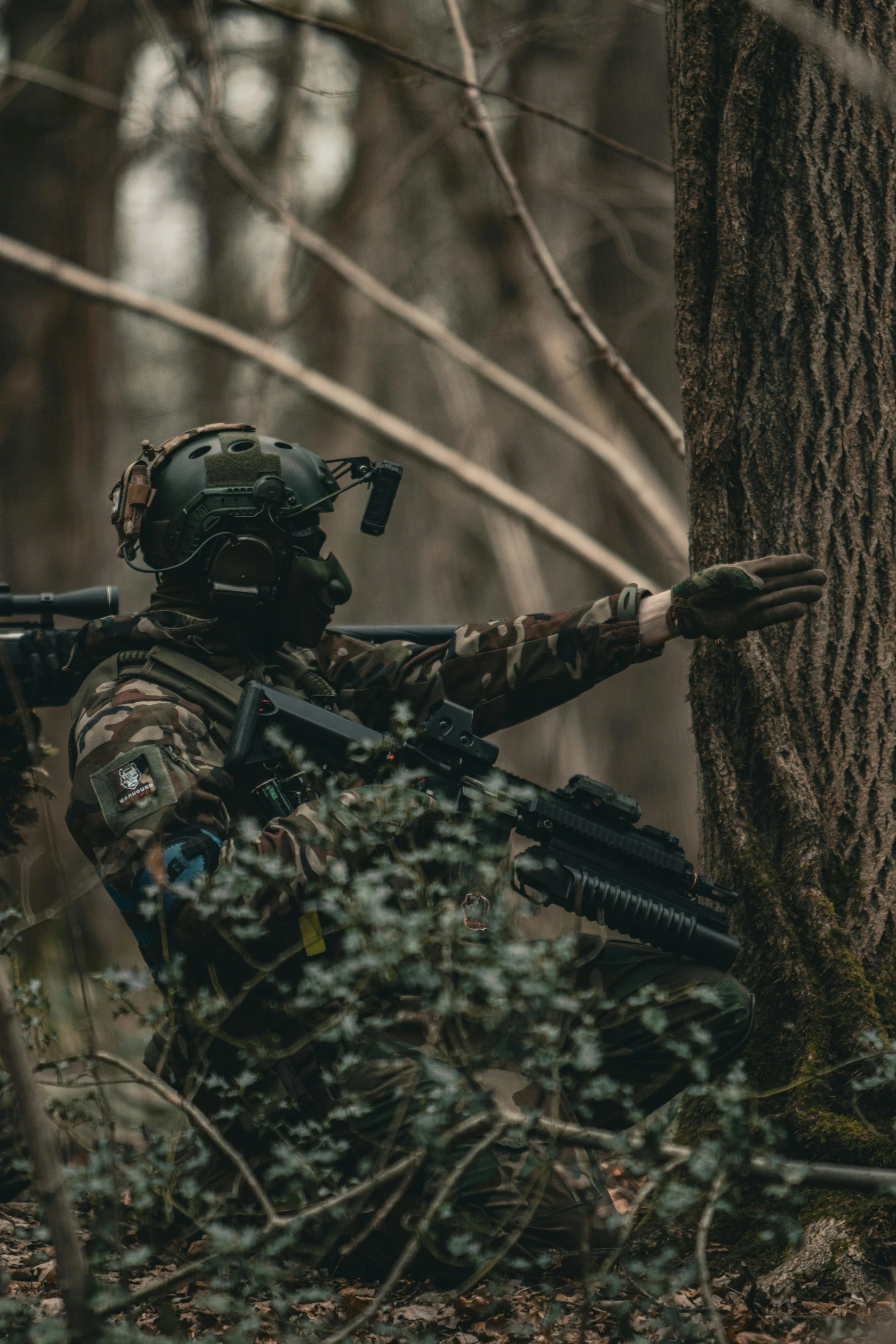 an armed man aims a rifle at the target