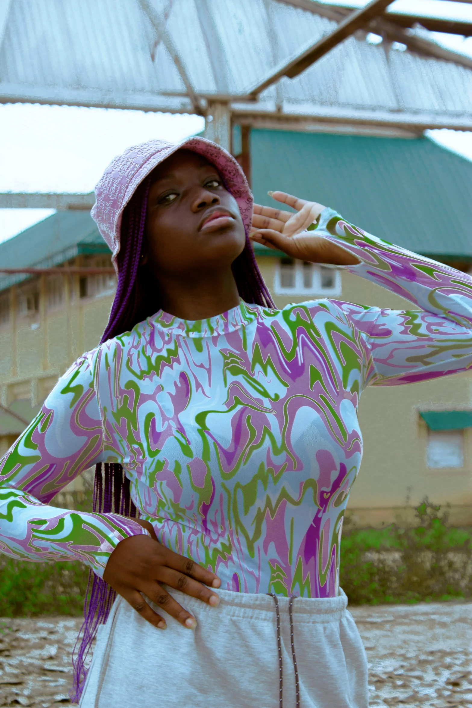 a woman is wearing a colorful printed shirt