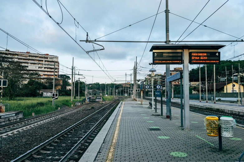 a train station is shown with several tracks and signs