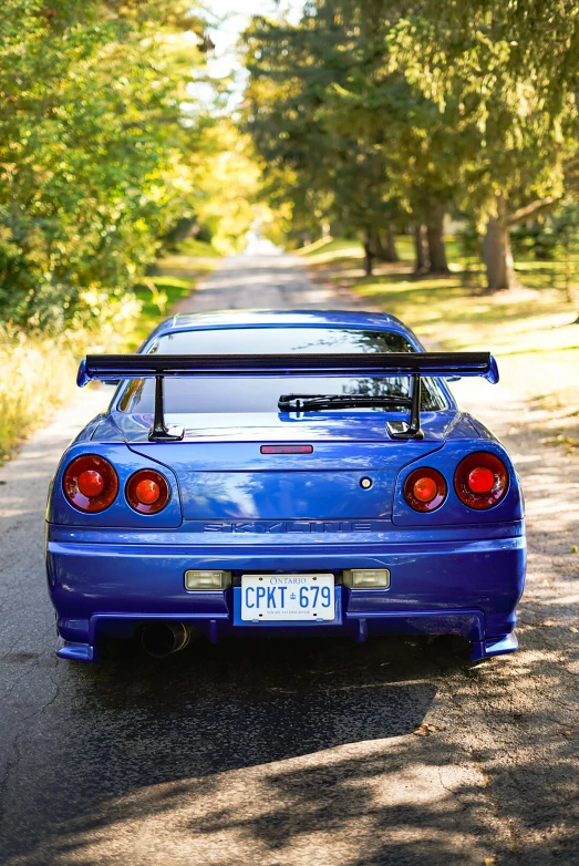 an automobile parked on the side of a road in the middle of the woods