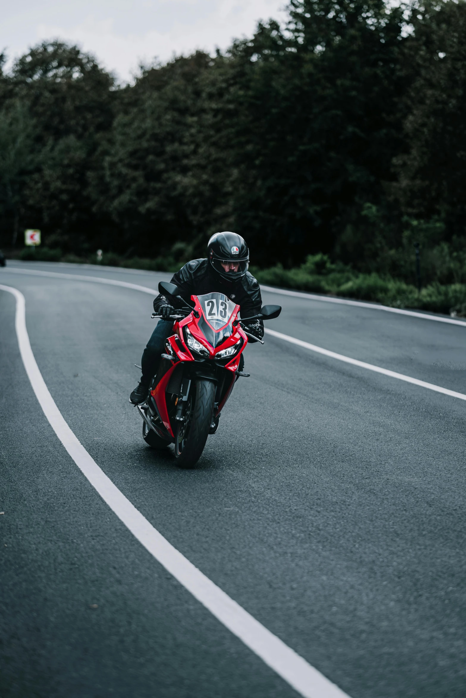 a person on a motorcycle taking off down the road