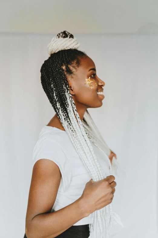 a young woman is smiling while wearing two pairs of hair