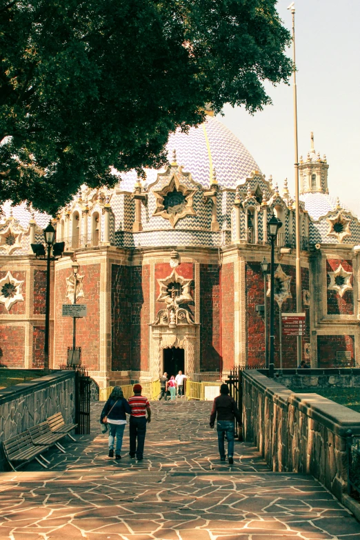 two people walking on a walkway towards the palace