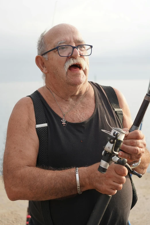 a man on the beach with his fishing rod