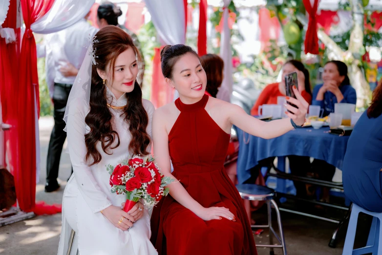 two women dressed in red pose for the camera