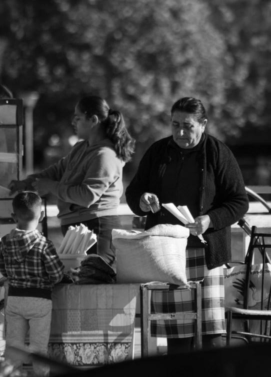 an older man and woman with a little child in the foreground and a baby boy in the background