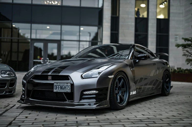 a gray car is parked in front of a building