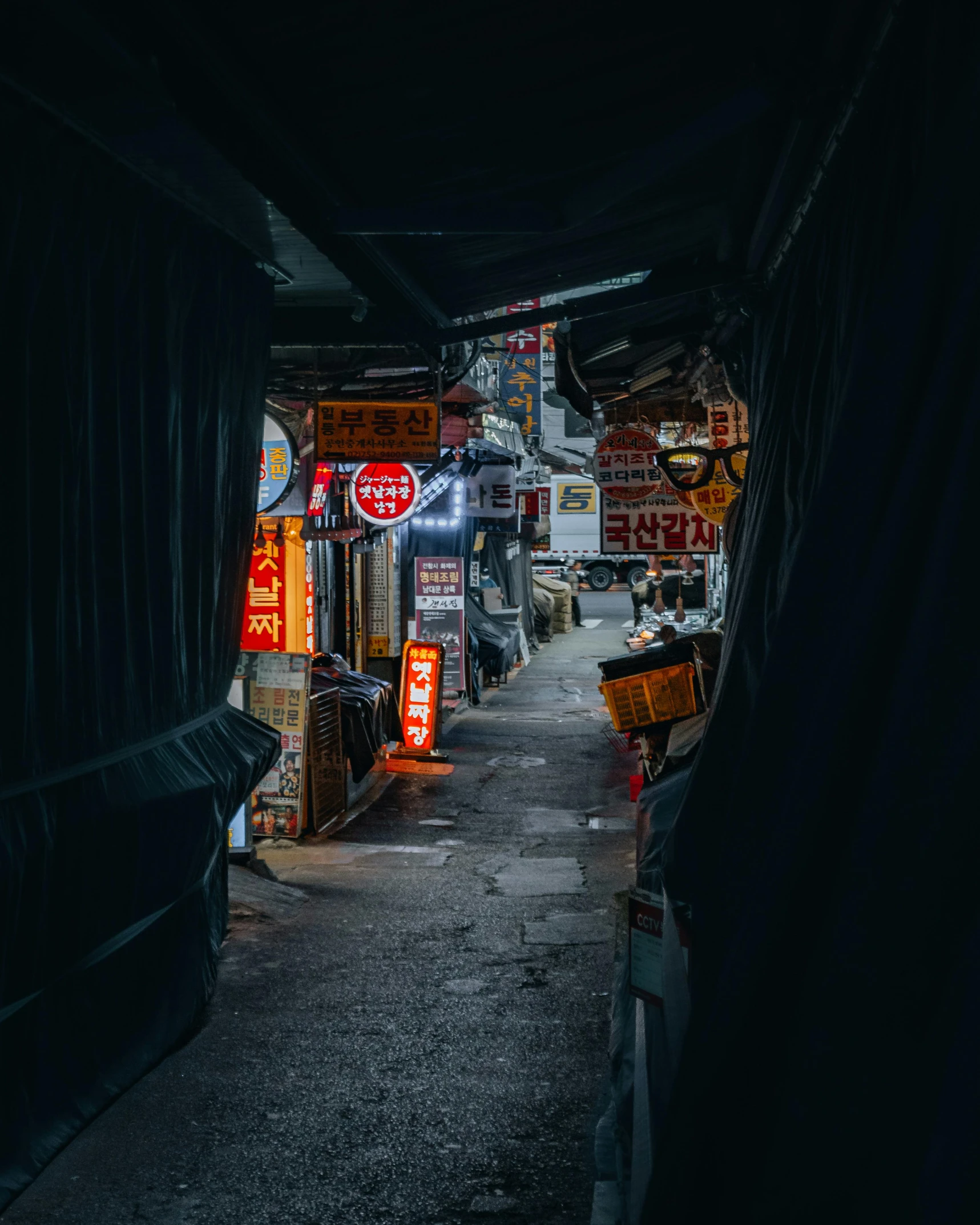 dark alley with signs and lights on the sides