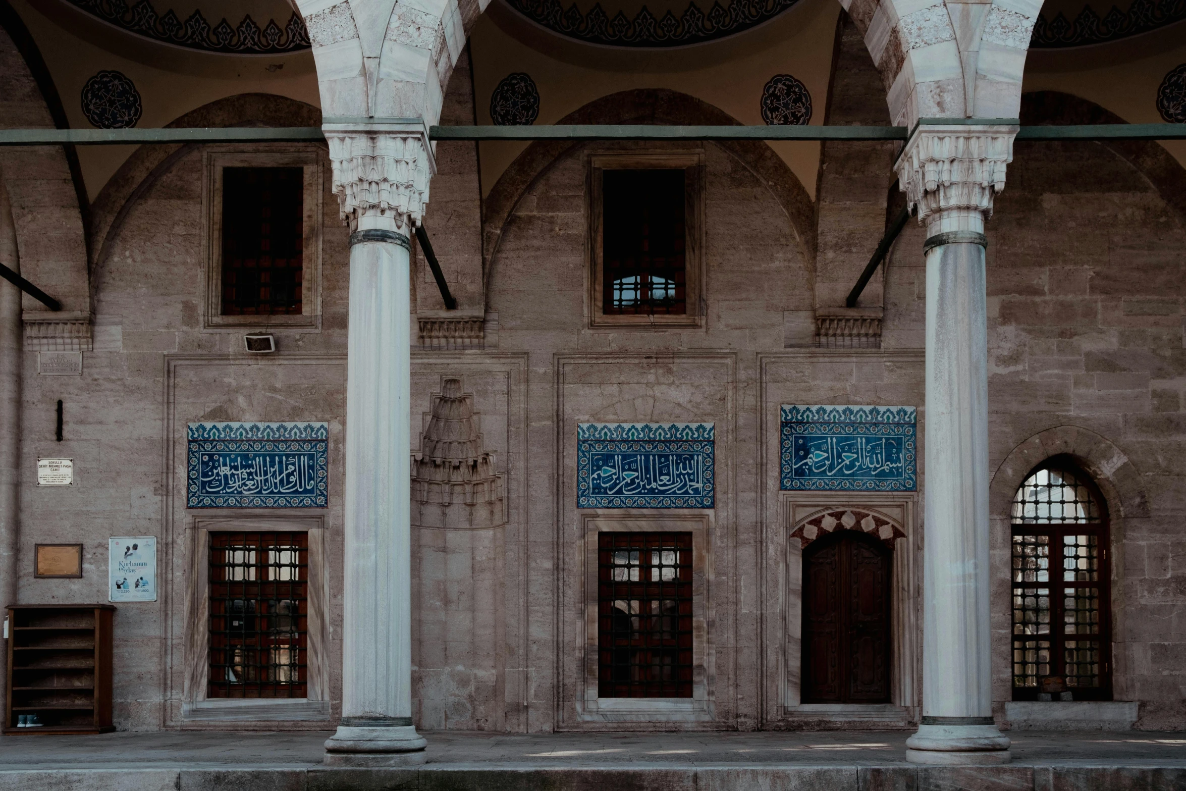 an old building with pillars, arches and stained glass windows