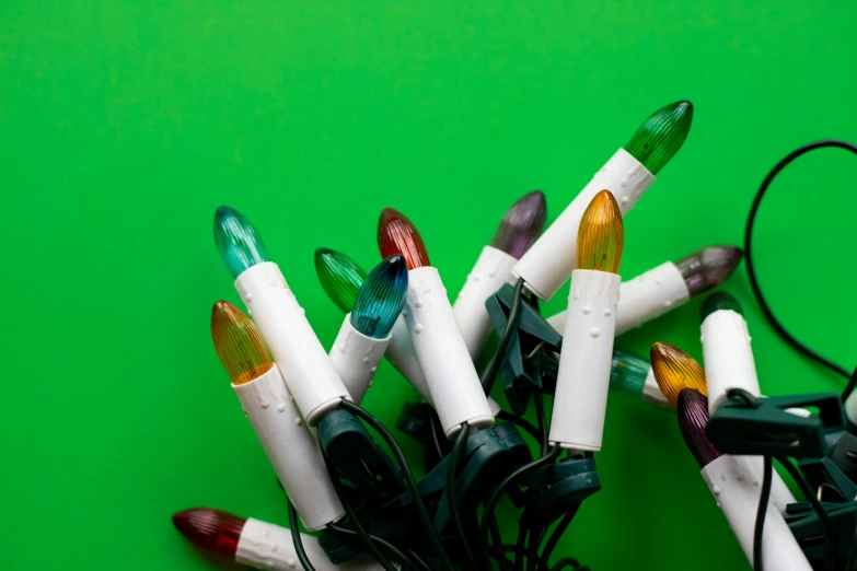 many colored lights and wires on a green background