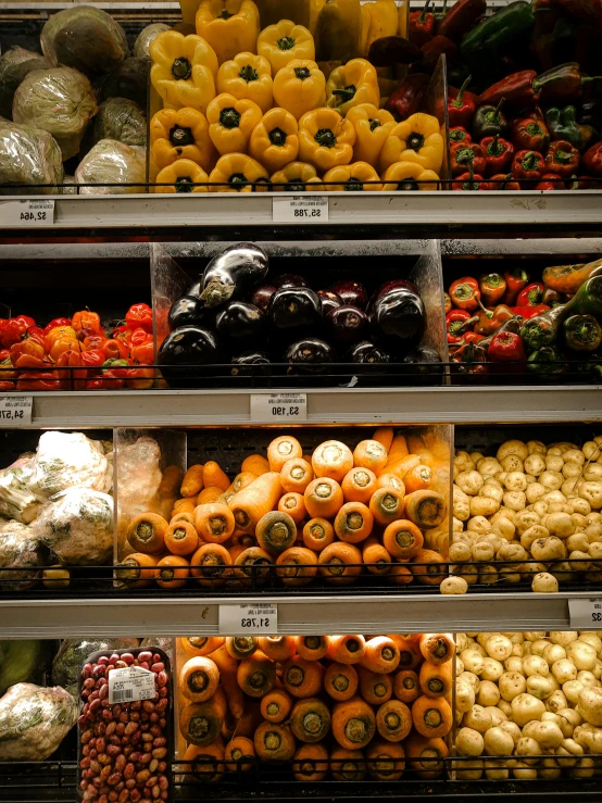 a produce section in a supermarket filled with lots of fruits and vegetables