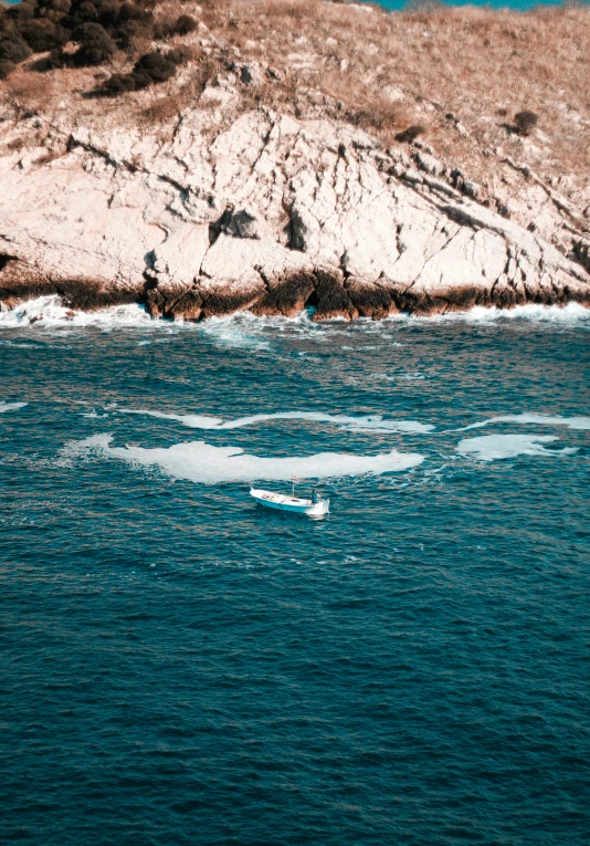 an ocean with ice floes floating by on a rocky shore