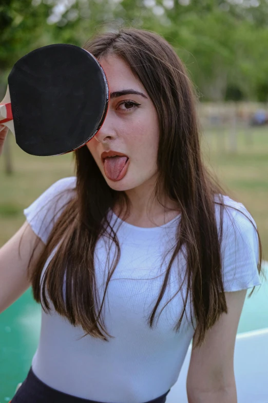 a woman is making a shocked face holding a paddle