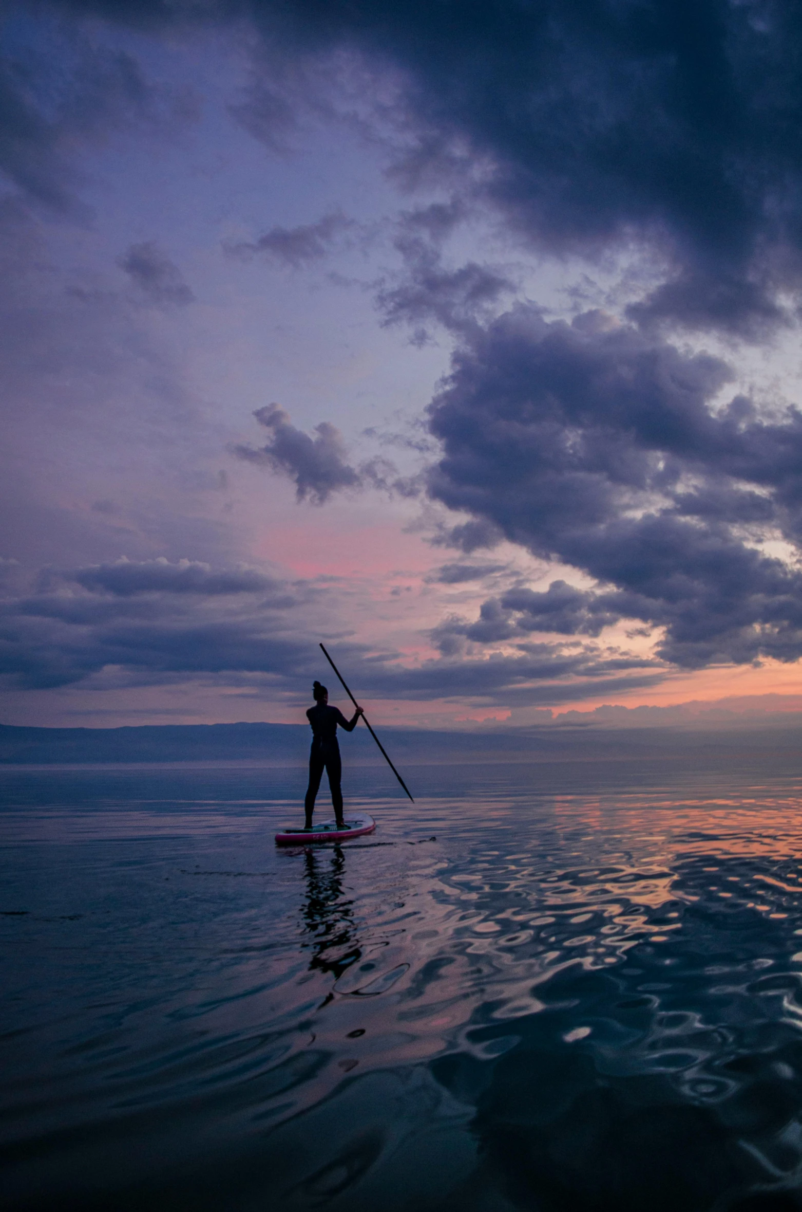 a person riding on top of a paddle board