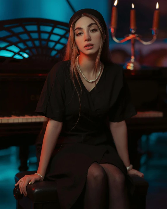 a woman with dark hair and black stockings sitting on a chair in front of a piano