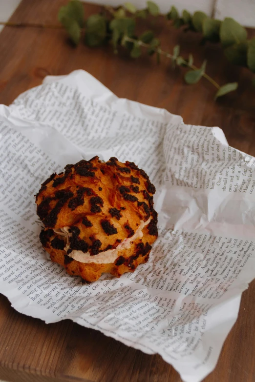 a pastry on some paper with some leaves