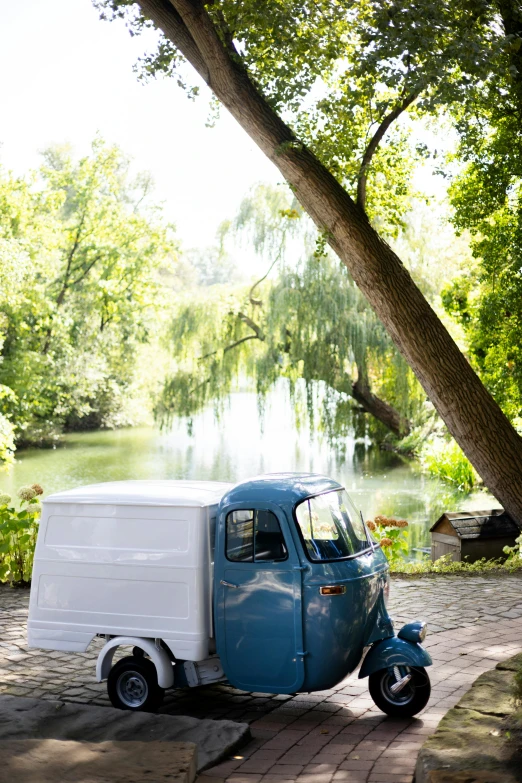 an old blue and white truck parked on the street