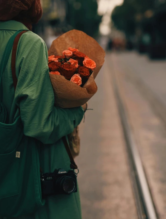 a woman with a bouquet of flowers in her hand