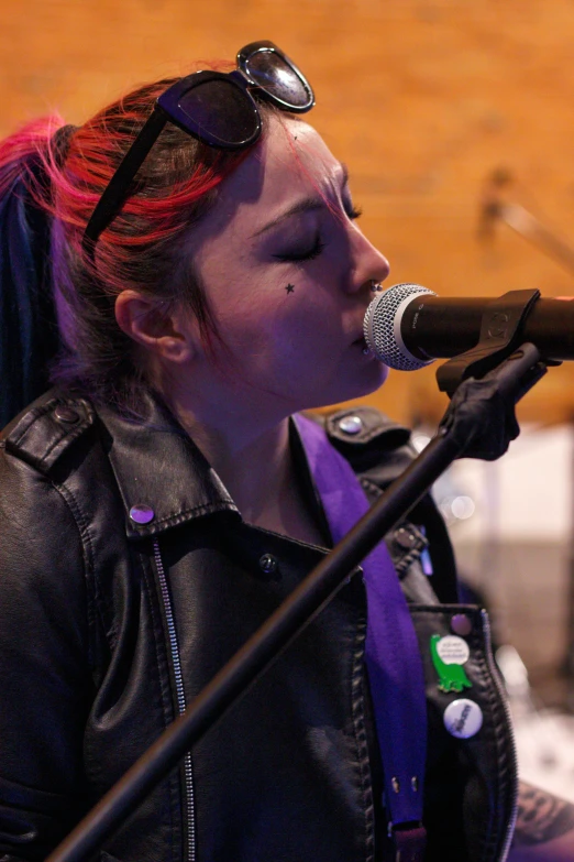 the singer has her head covered with sunglasses as she sings