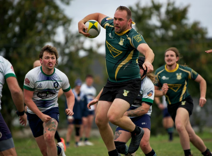 a man in a rugby uniform holding a ball