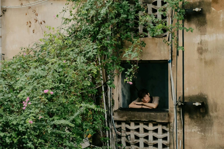 there is a person resting his head on the window sill