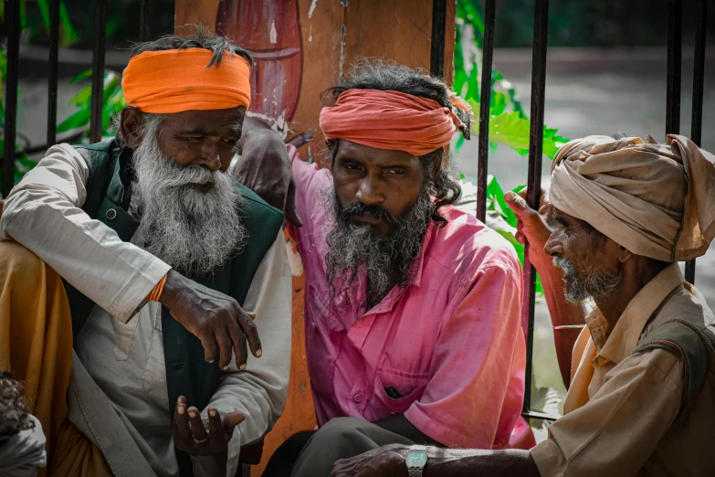 four men in turbans with a woman