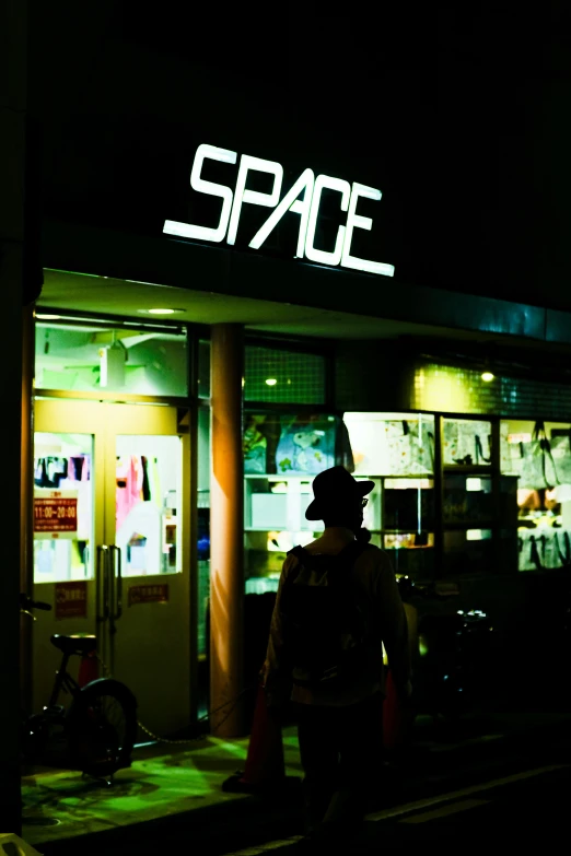 man standing in front of building at night