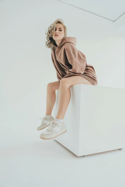 a woman sits on the top of a stool