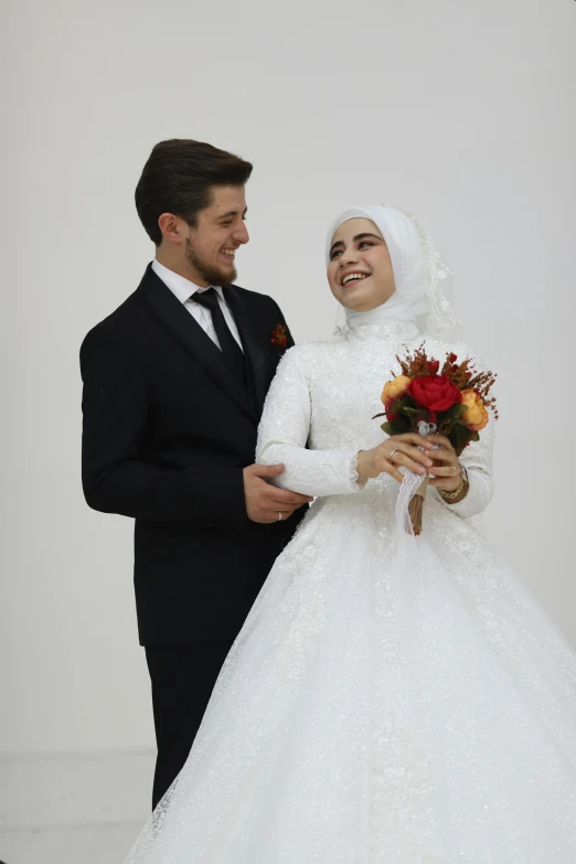 a man and woman in formal wear standing near each other