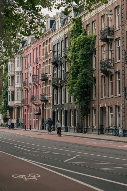 a man on a bike riding by several buildings