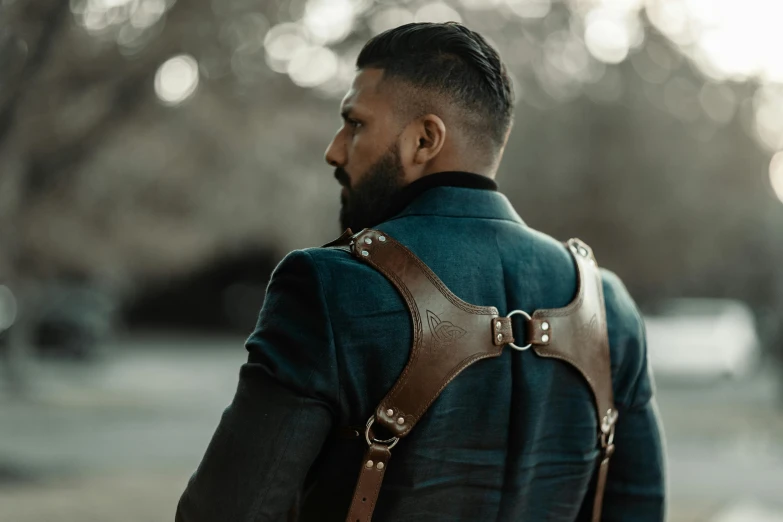 a man with beard wearing leather ces