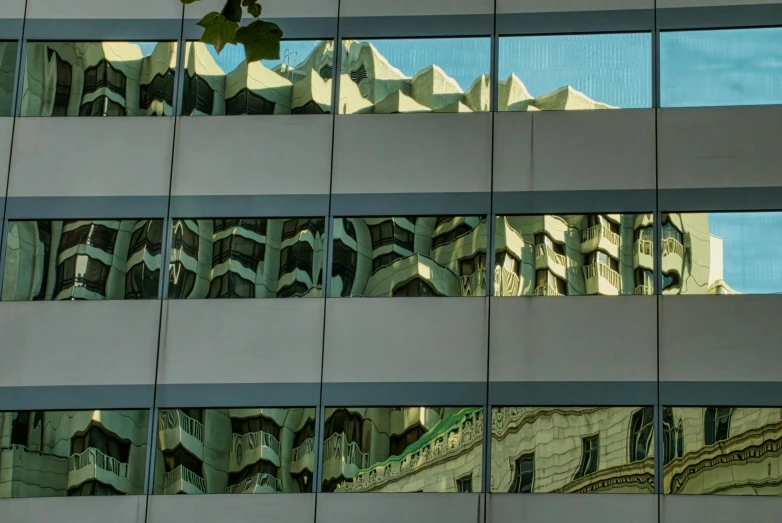 a reflection of a building with a clock tower on the side