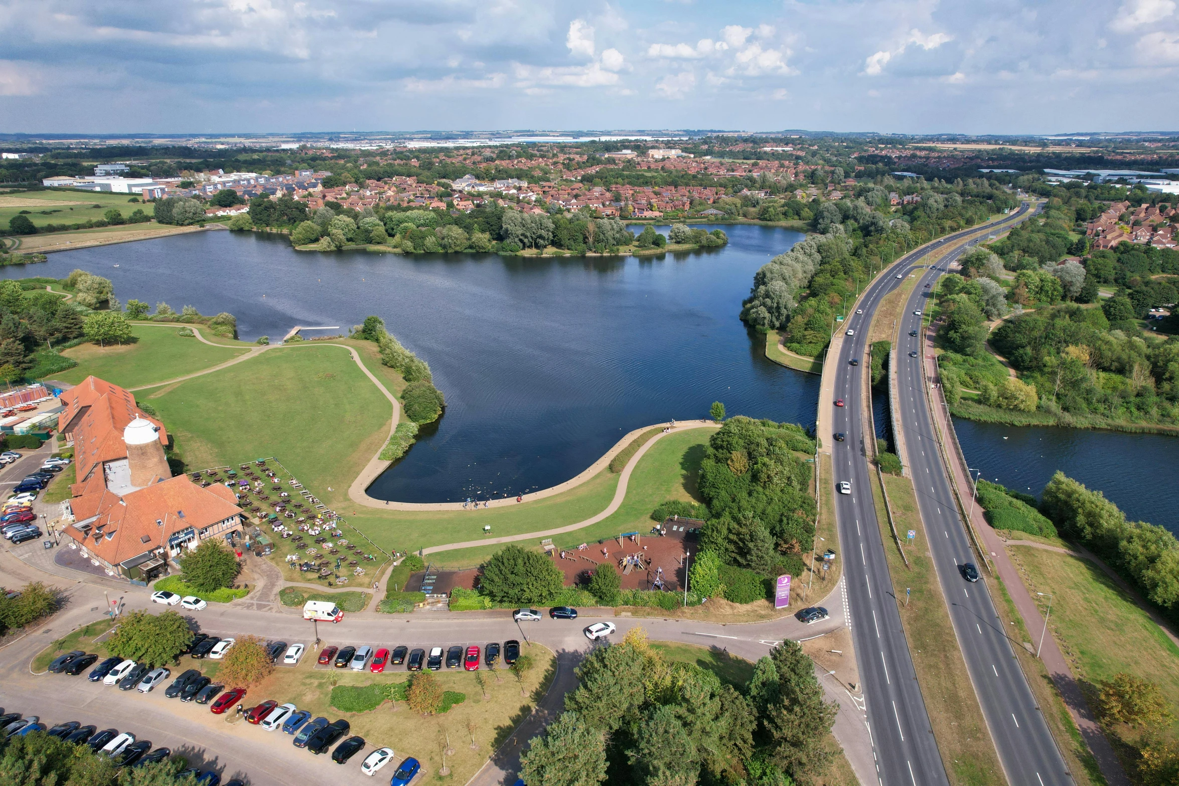 an aerial view of a lake with a river in the background