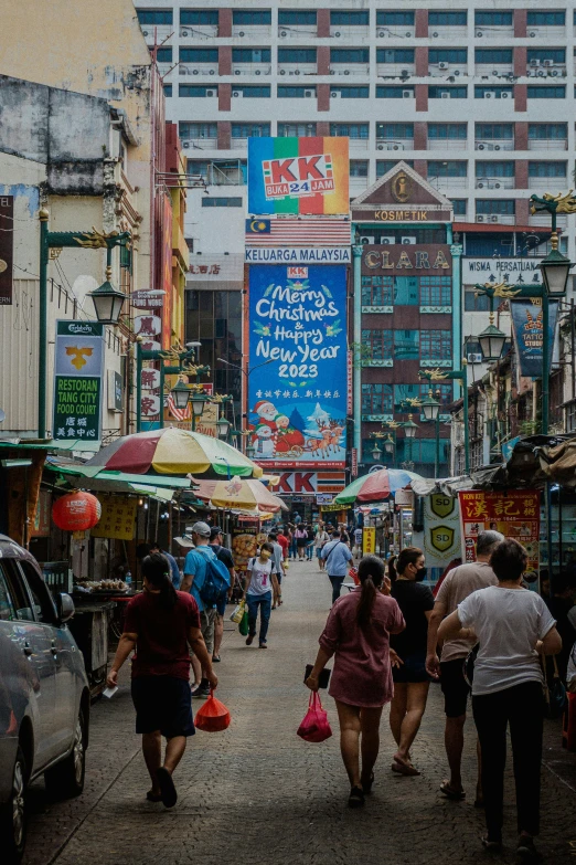 several people are shopping on a crowded street