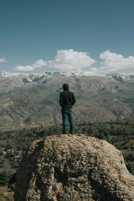 a man is standing on top of a hill