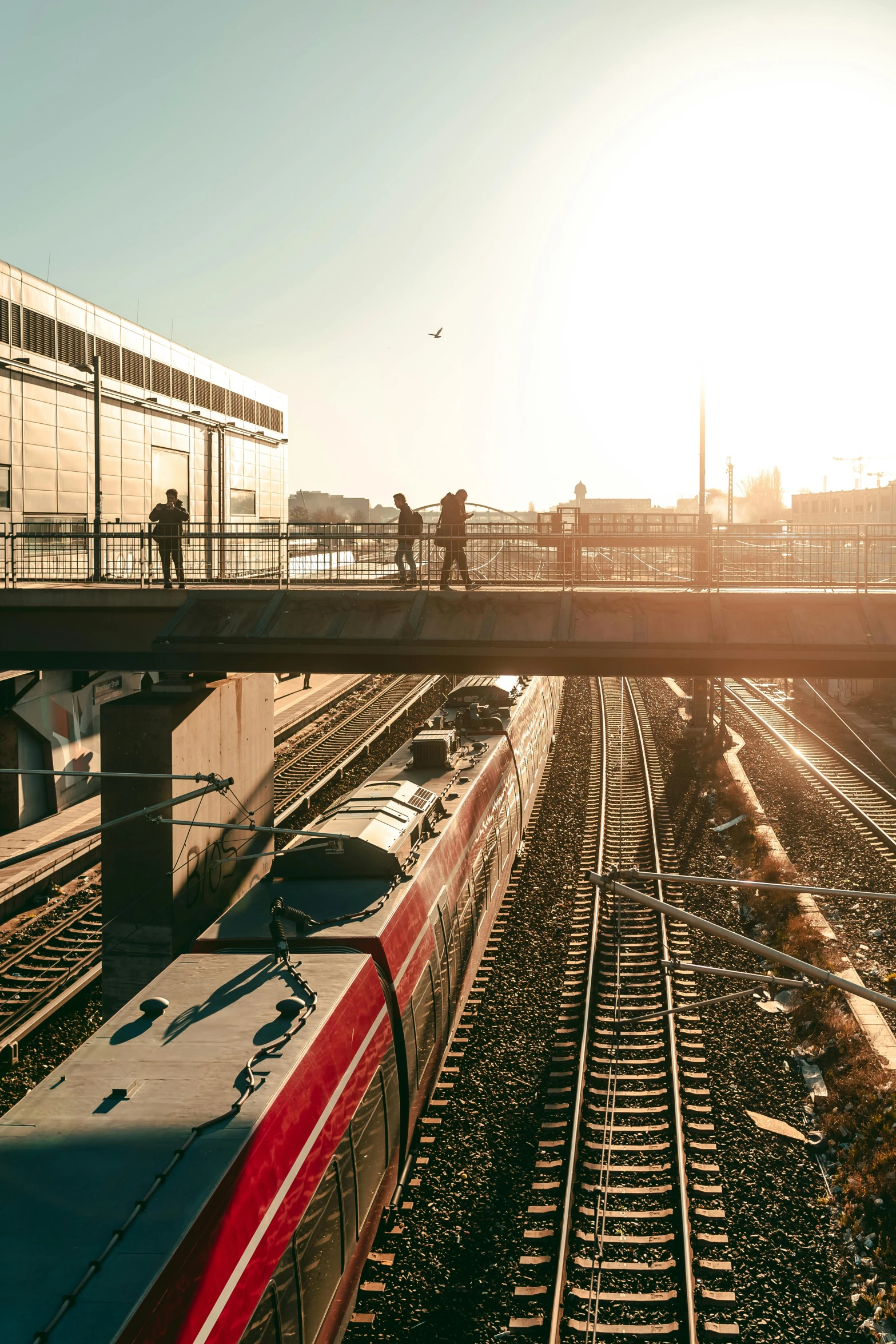 the light rail train is passing by as the sun sets