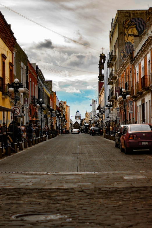 a street has many brown buildings and colorful graffiti