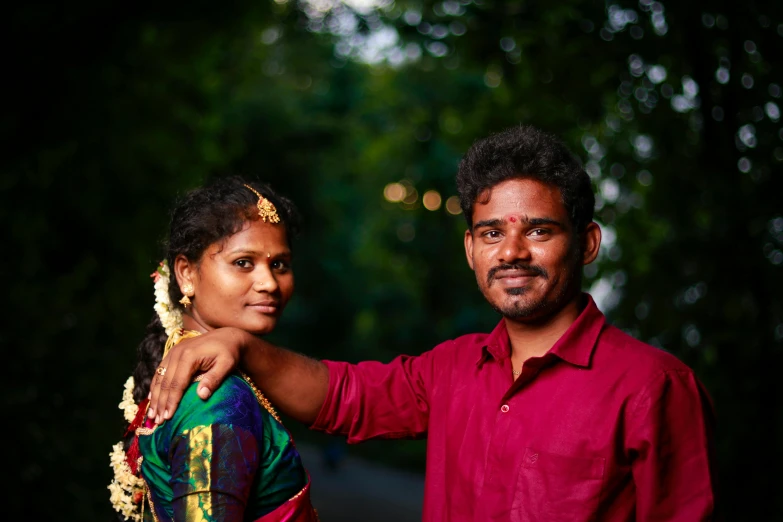 a man is standing next to a woman and her head wrapped around her