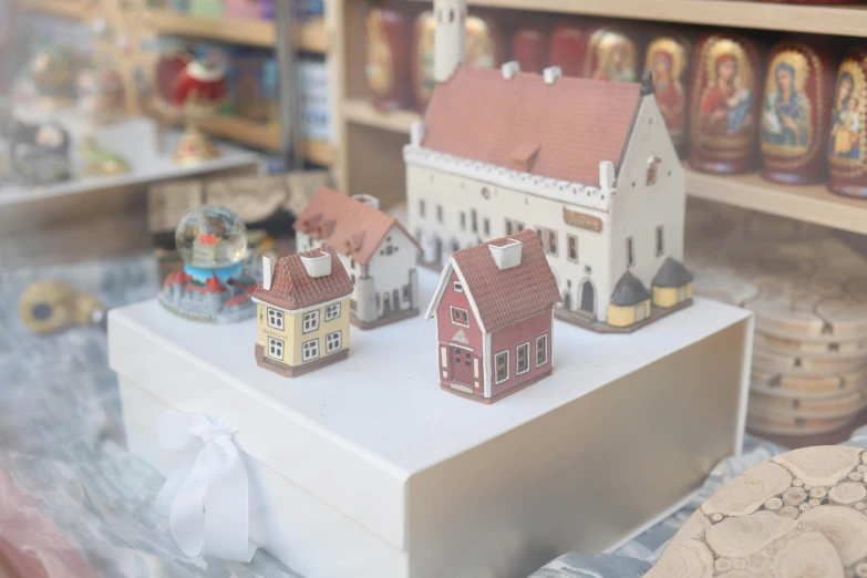 a toy display case in a toy store filled with tiny model buildings