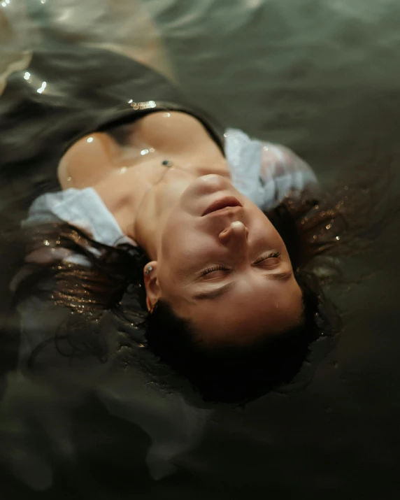 a woman floating in the water and looking up