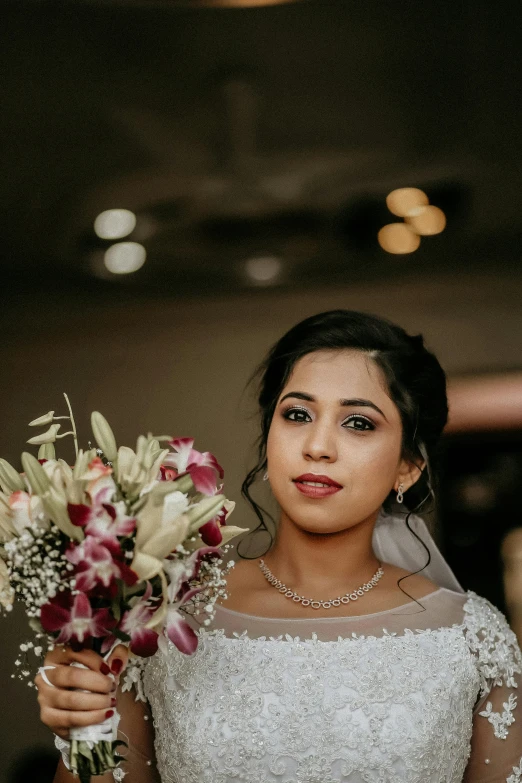 the bride is holding her bouquet at her wedding