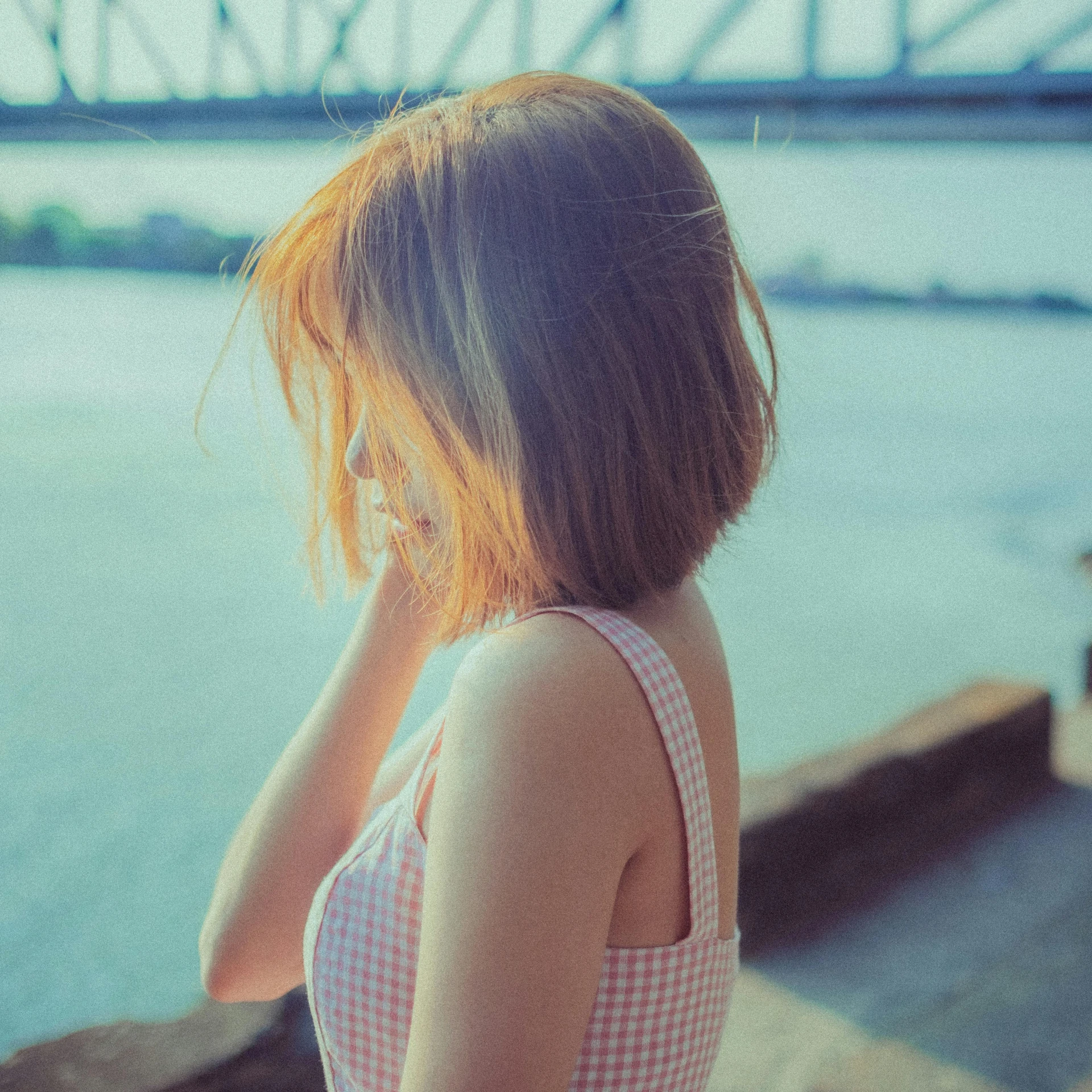 a girl standing outside by a river with an artistic picture on her face