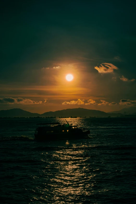 a boat floating on top of a lake under a sun