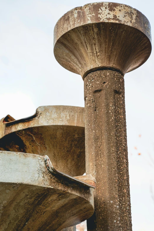 old weathered and rusted concrete structure against blue sky