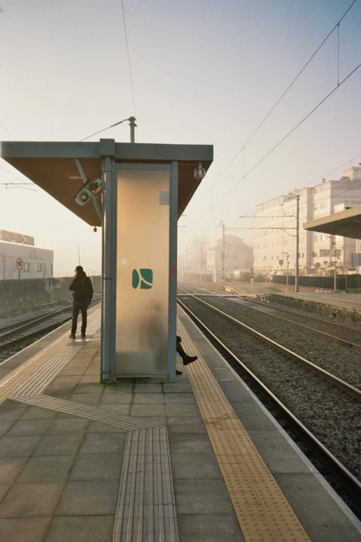 a man waiting for the train to arrive