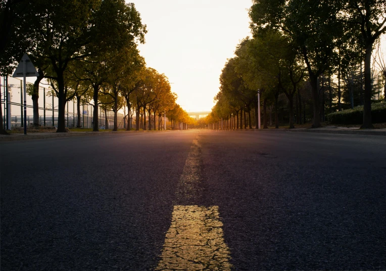 the sun shining on an empty city street