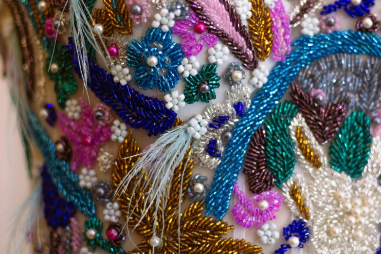 a woman's colorful bead and beaded dress