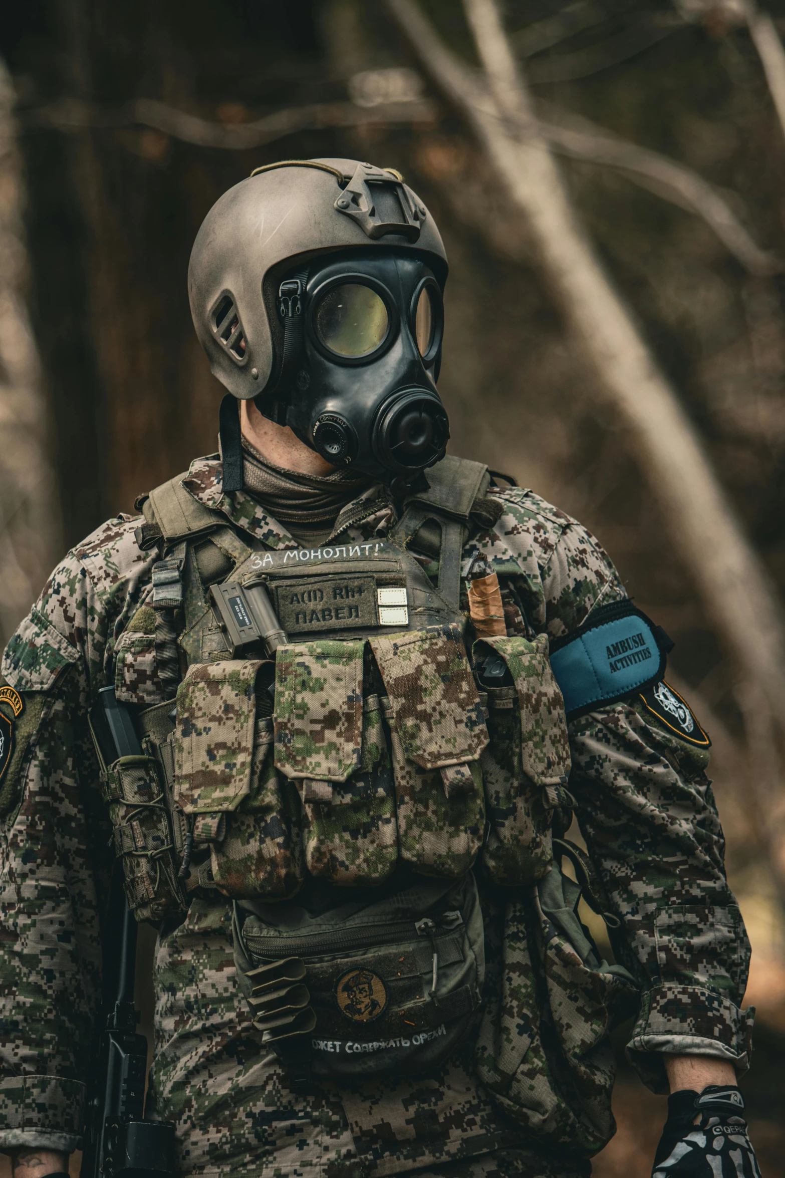 man in camouflage gear wearing a gas mask